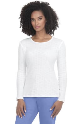A white long-sleeve tee shirt with a textured pattern, displayed on a model. The tee has a round neckline and fitted sleeves.