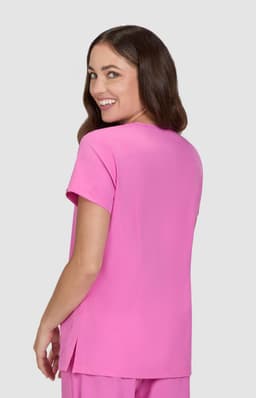 A pink short-sleeved top is displayed on a model, showing the back view and a stylish cut.