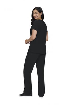 A woman in a black Sari Top and matching pants, smiling and facing slightly away from the camera.