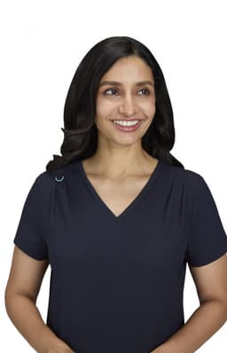 A navy Sari Top featuring a V-neck design, displayed by a smiling woman with long hair. The top has a logo on it.