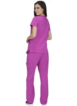 A woman wearing a pink Sari Top and matching pants, facing away from the camera.