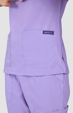 A top in a soft lavender colour with two large pockets and a logo tag.