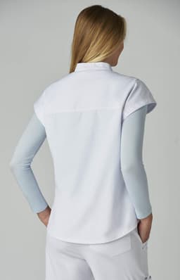 A light blue and white shirt with short sleeves and a back yoke, featuring a simple design.