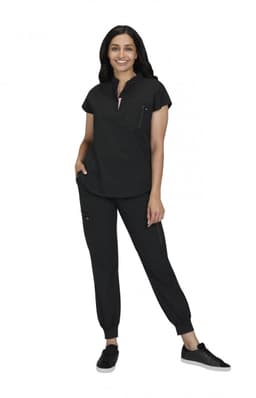 A woman models a black two-piece outfit, featuring a short-sleeve top and tapered pants with pockets.