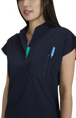 A navy blue top with a half-zip collar, featuring a pocket and a pen in the chest pocket. It has a logo.
