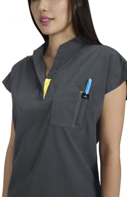 A grey top with short sleeves featuring a pocket and a yellow zipper detail, worn by a model.