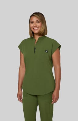 A top in olive green with a relaxed fit and a chest pocket, featuring a small branded logo.