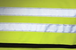 A bright yellow shoulder bag with reflective white stripes and black trim, featuring a logo.