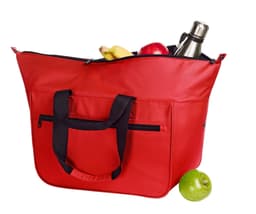 A large red cooler bag with black handles, filled with a drink bottle, bananas, apples, and a green apple.