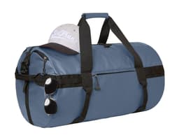 A blue duffle bag with black straps, a grey cap resting on top, and sunglasses attached to the side.