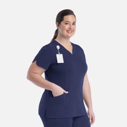 A curved V-neck top in navy blue with a pocket and a name tag holder. Features a logo on the left side.