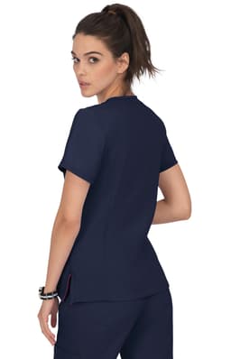 A model wearing a navy blue scrub top with a simple design and a subtle logo on the back.