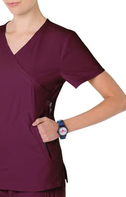 A burgundy scrub top with a V-neck design and a visible side pocket, worn with a wristwatch.