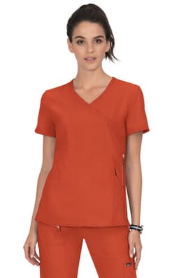 A medical scrub top in a vibrant orange colour, featuring a wrap-style design and a logo on the side.