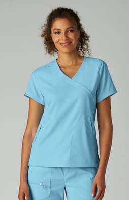 A top in light blue, featuring a V-neck design and short sleeves, worn by a smiling model.