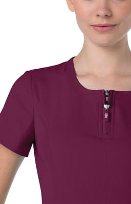 A burgundy top with a short zipper and a round neckline, featuring short sleeves. It includes a logo on the zipper.
