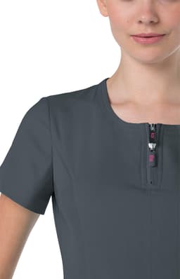 A close-up of a grey top featuring a zippered neck and short sleeves, with a logo on the zipper pull.