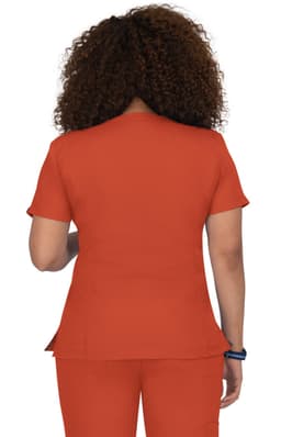 A fitted orange top with short sleeves and a peplum style, viewed from the back. Features a logo on the side.