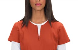 An orange top with a front zip and short sleeves, featuring a round neckline and a logo on the side.