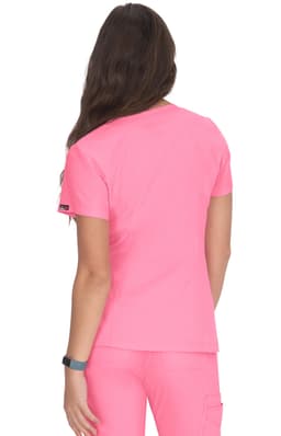 A woman wearing a bright pink top, viewed from the back, with a logo on the sleeve.