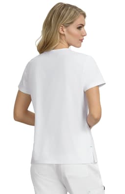 A woman is wearing a plain white short-sleeved top, viewed from the back. The top features a logo.