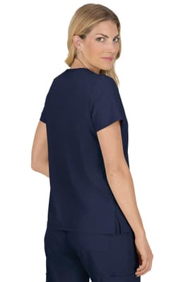 A woman wearing a navy blue top, viewed from the back, featuring short sleeves and a relaxed fit.