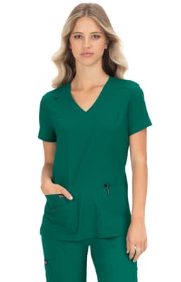 A green medical scrub top with a V-neck design and two front pockets, featuring a logo on the sleeve.