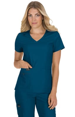 A woman in a teal scrub top with a v-neck and short sleeves, featuring pockets.