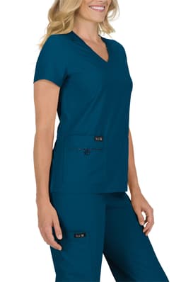 A scrub top in teal with a v-neck and two front pockets, paired with matching scrub pants. The outfit has a logo.