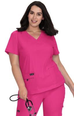 A pink medical scrubs top with a V-neck design, featuring pockets and worn by a model holding a stethoscope.