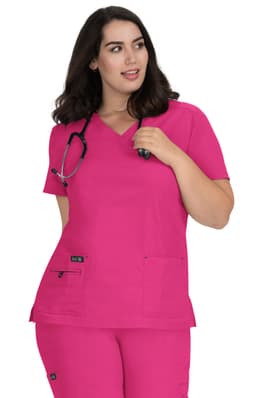 A bright pink scrub top with a V-neck, featuring two front pockets and a logo. A stethoscope is worn around the neck.