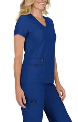 A woman wearing a navy blue scrub top with a V-neck and two front pockets, paired with matching pants.