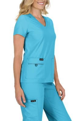 A vibrant teal scrub top worn by a model, featuring a V-neck and two front pockets. The top has a logo.