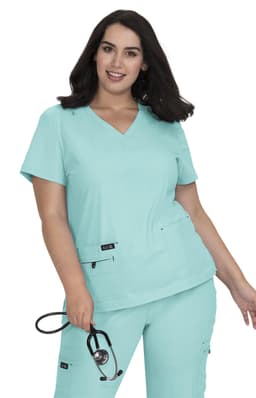A model wearing a turquoise medical scrubs top, featuring a V-neck design and a logo on the pocket.