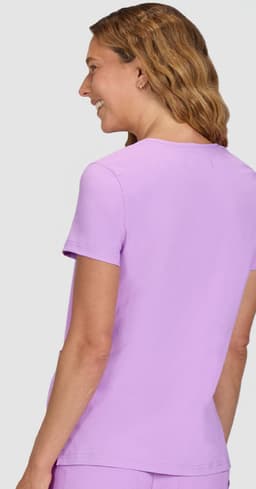 A lilac short-sleeve top with a round neckline, featuring a smooth fabric and a logo on the back.