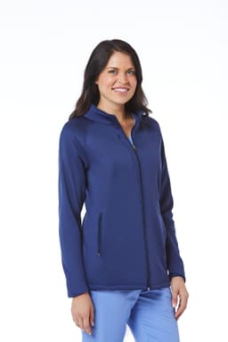 A woman is wearing a navy fleece jacket with a zip front and side pockets, featuring a logo.
