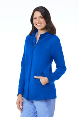 A woman wearing a blue fleece jacket with a zip and pockets, featuring a logo on the design.