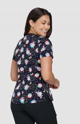 A printed top featuring a dark navy background with colourful patterns of cartoon characters and shapes.