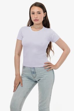 A light purple fitted t-shirt with short sleeves, modelled by a person in light blue jeans. The shirt features a logo.