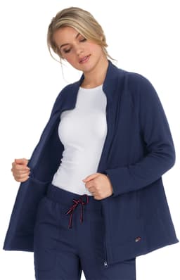 A navy blue wellness jacket featured on a model, showcasing a relaxed fit and a zippered front.