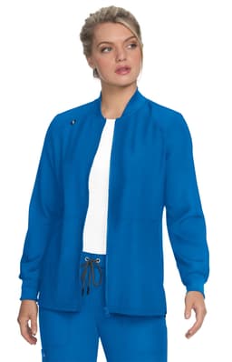 A woman wearing a fitted blue jacket, with a simple design and a standing collar, stands against a white background.