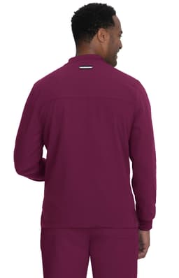A man wearing a maroon jacket, viewed from the back, with a logo displayed on the upper back.