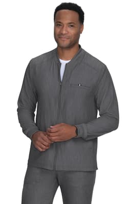A man is wearing a grey jacket with a zip, featuring a pocket on the chest. The jacket has a simple design.