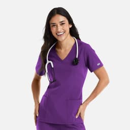 A woman models a purple double V-neck top, wearing a stethoscope around her neck. The top features two side pockets and a logo.