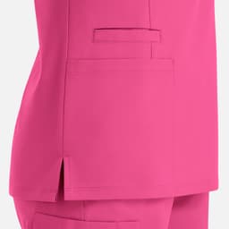 A vibrant pink double v-neck top featuring side slits and a pocket detail. The garment has a sleek, modern design.