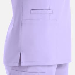 A lilac women's double V-neck top featuring side slits and a pocket on the lower left side. It has branding.