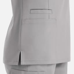 A grey double V-neck top featuring side slits and a patch pocket on the back. The garment has a subtle, sleek design.