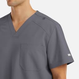 A grey men's v-neck top featuring a chest pocket and a logo on the sleeve.