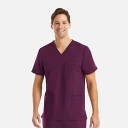 A man wearing a purple v-neck scrub top with three pockets, featuring a logo.