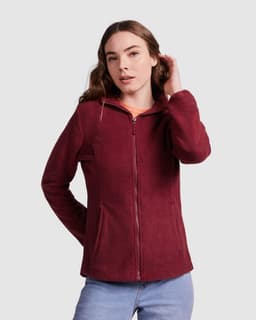 A deep burgundy women's fleece jacket with a front zip and side pockets, featuring a logo on the chest.